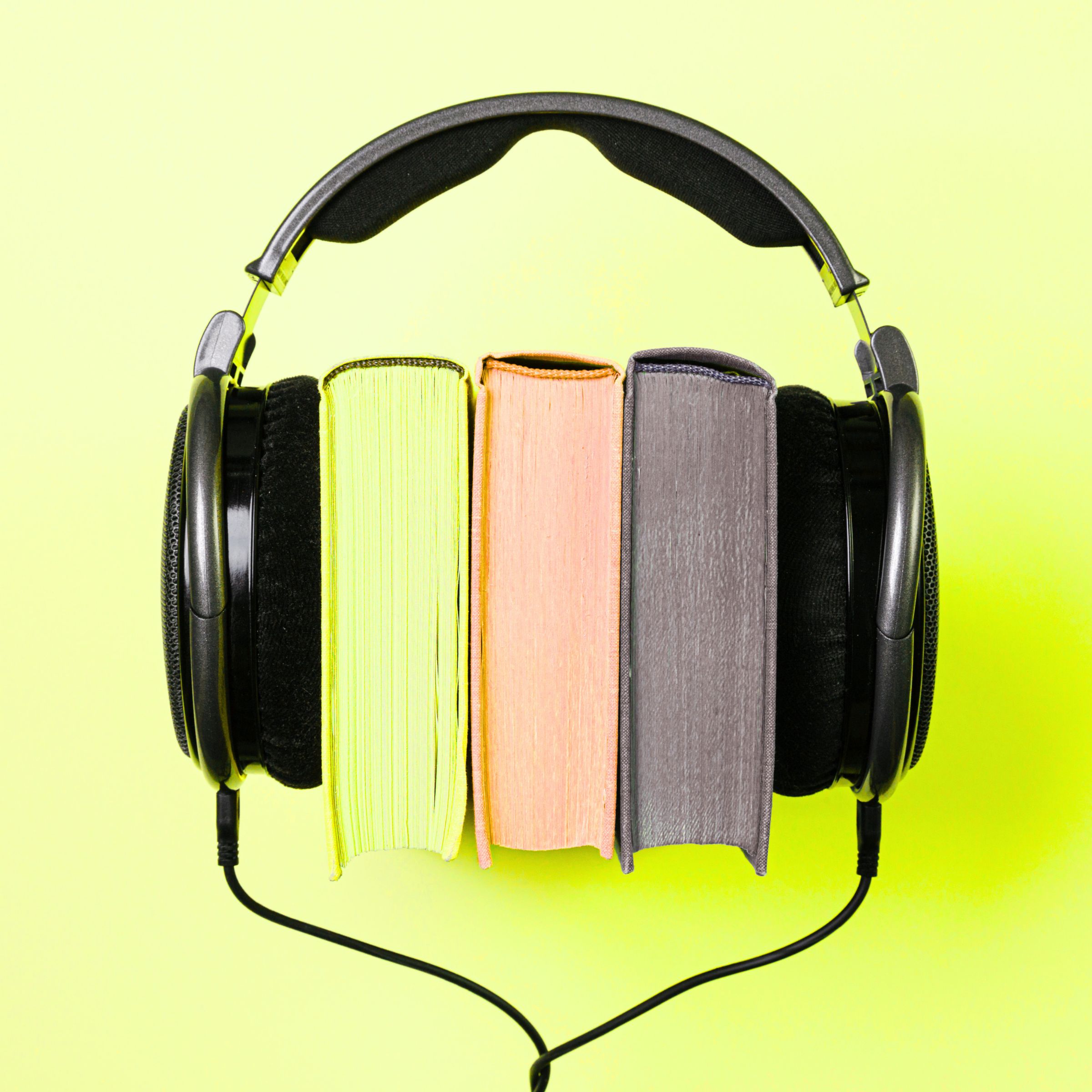 Headphones resting on a stack of books